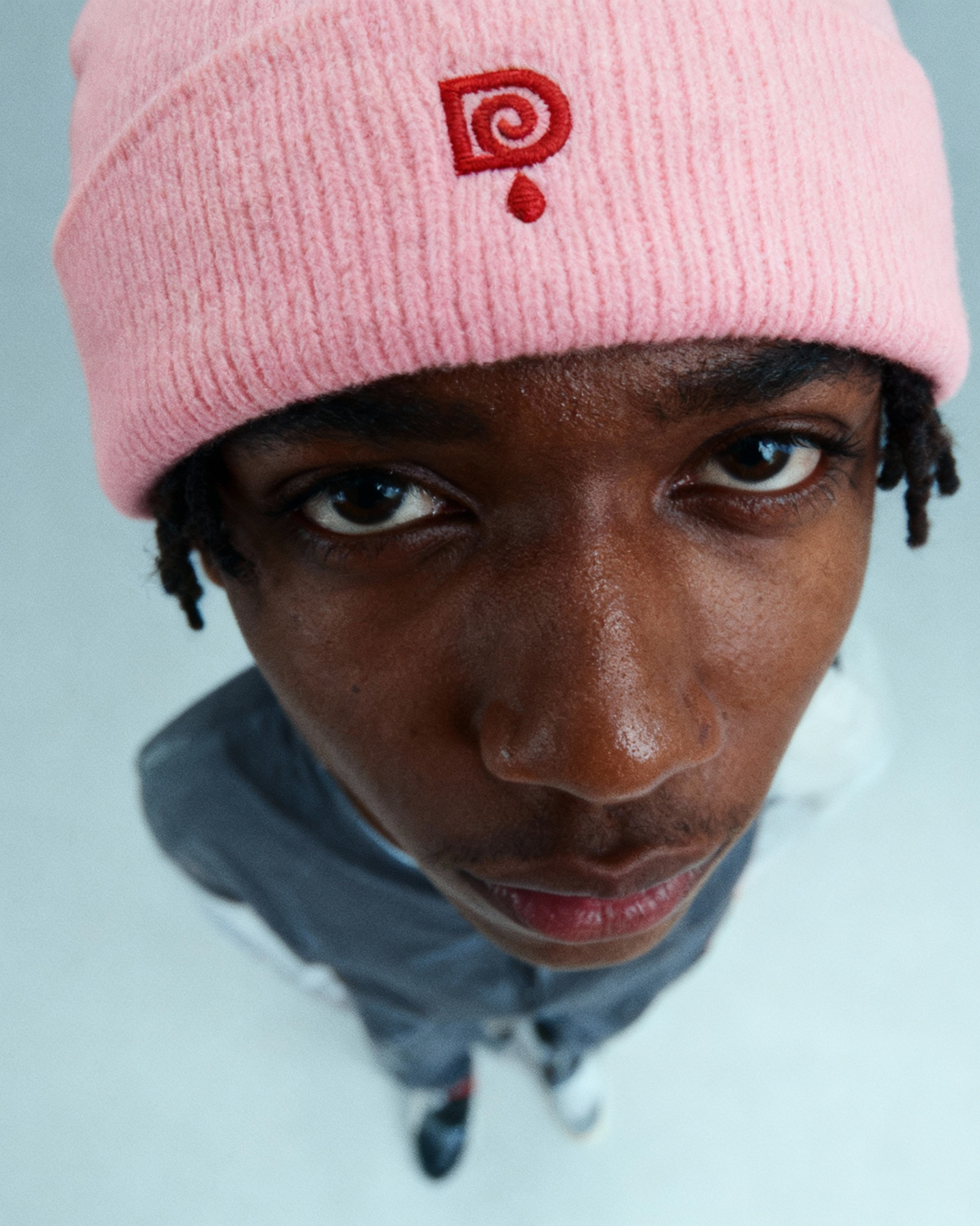 Editorial close-up, pink knit beanie, DRIPARA lookbook.